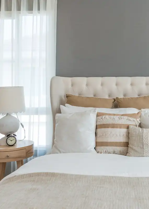 Home 10 bedroom with a bed and pillows. table lamp.